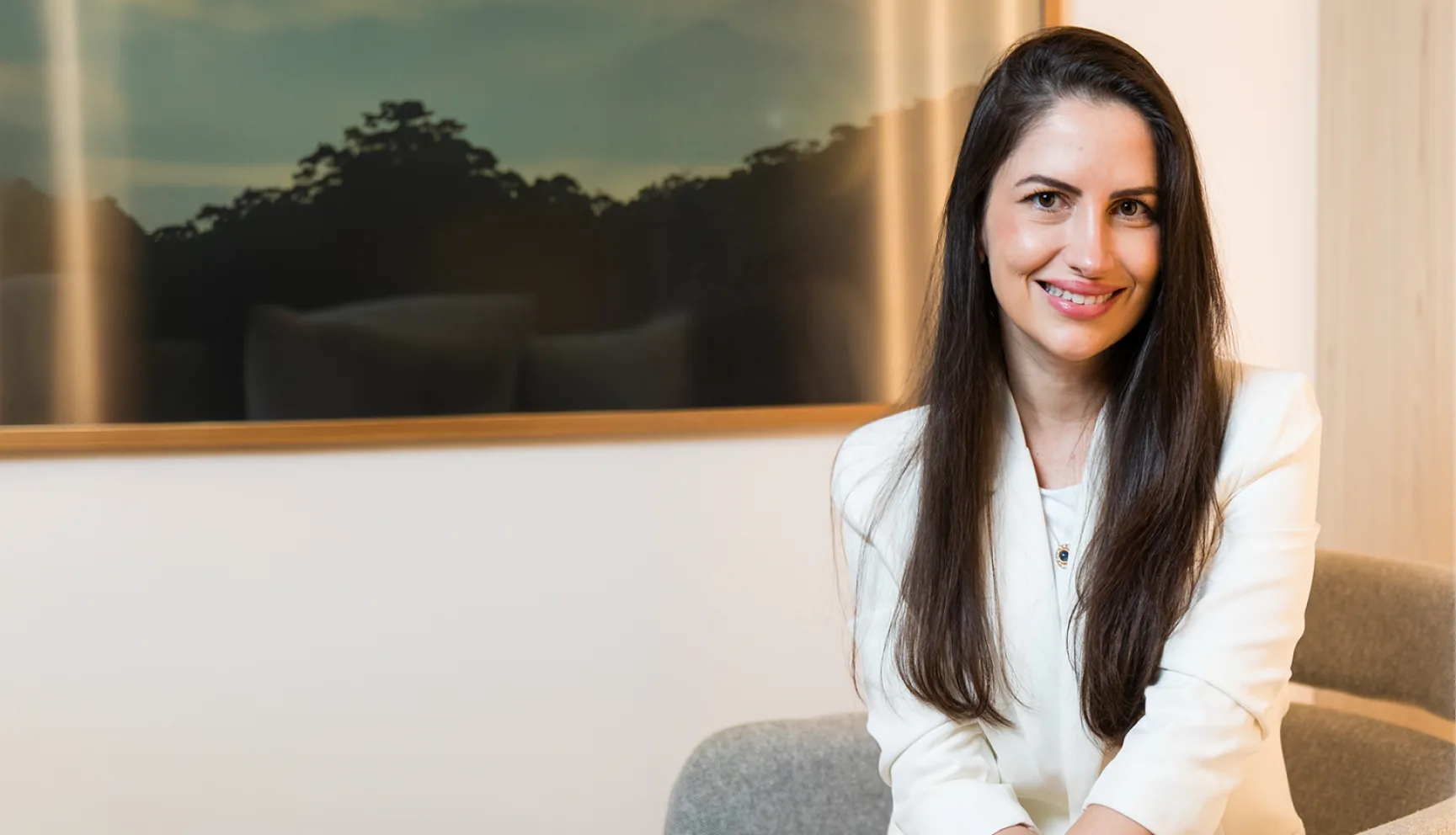 Dra. Renata Pina Barata, cardiologista, sorrindo em seu consultório no Rio de Janeiro